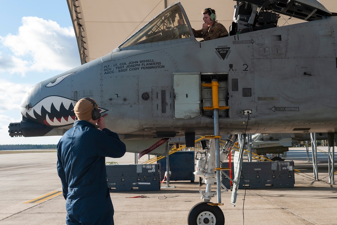 Photo of Col. Walls and Airman testing a communication cord