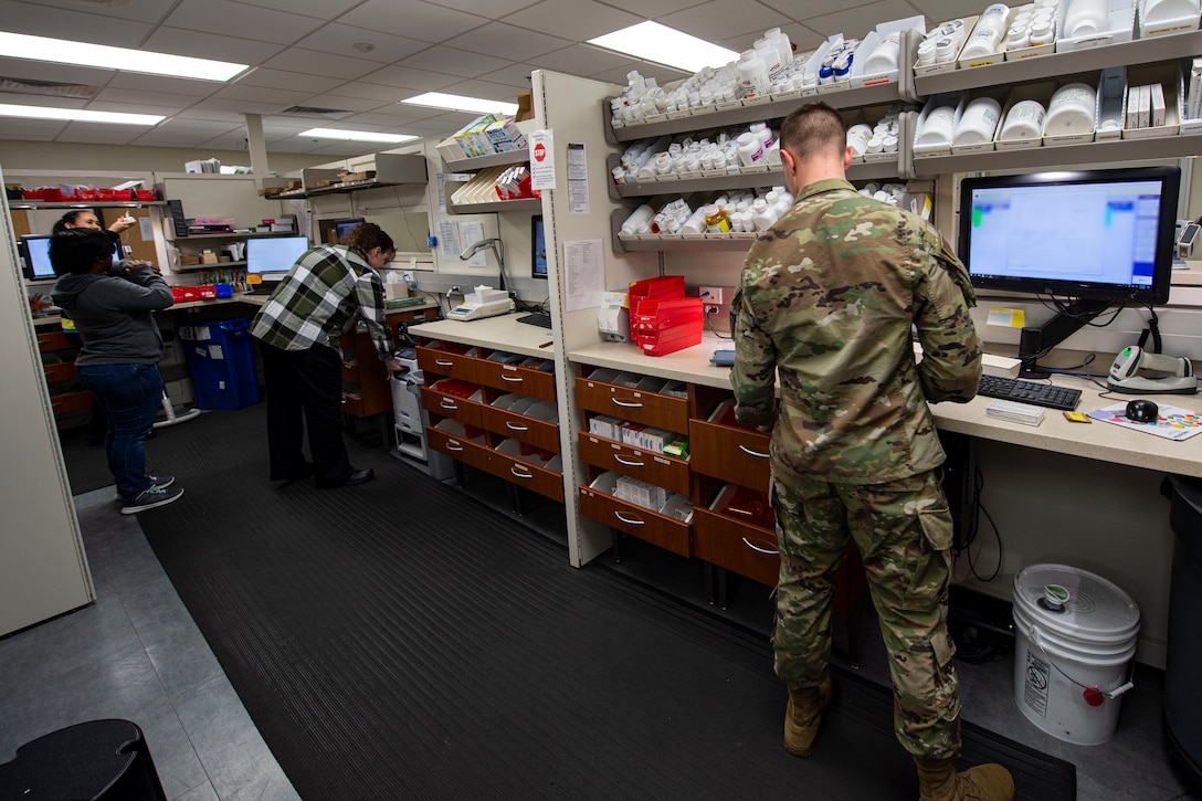 Photo of pharmacy technicians assigned to the 23d Medical Support Squadron processing prescriptions.