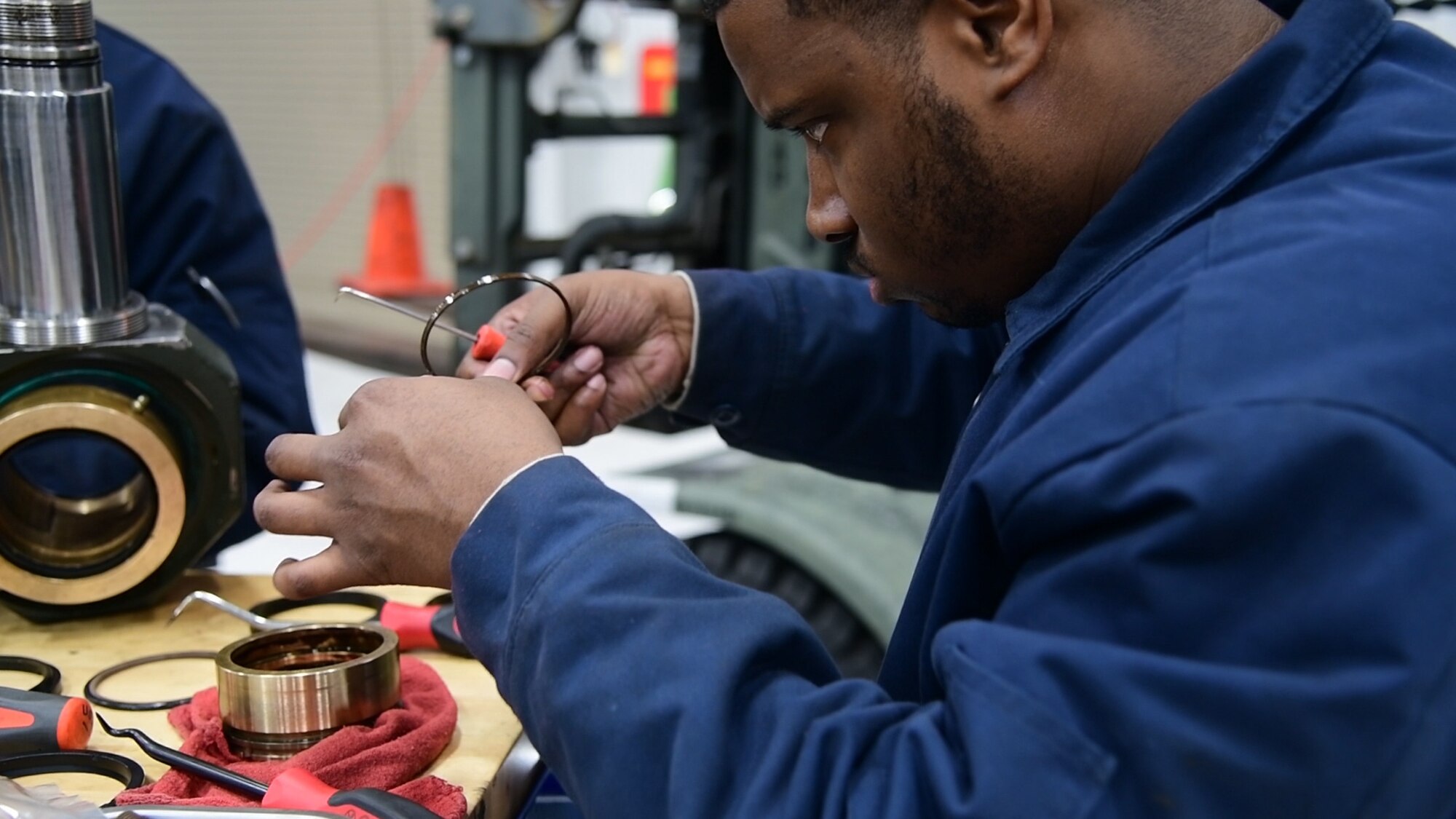 Staff Sgt. Leonard James, 436th Logistic Readiness Squadron vehicle maintenance, repairs a hydraulic component for a k-loader at Dover Air Force Base, Del., Jan. 29, 2020. James lost his fiancé and unborn daughter in a 2010 car accident while attending vehicle maintenance technical training. (U.S. Air Force photo by Tech. Sgt. Laura Beckley).