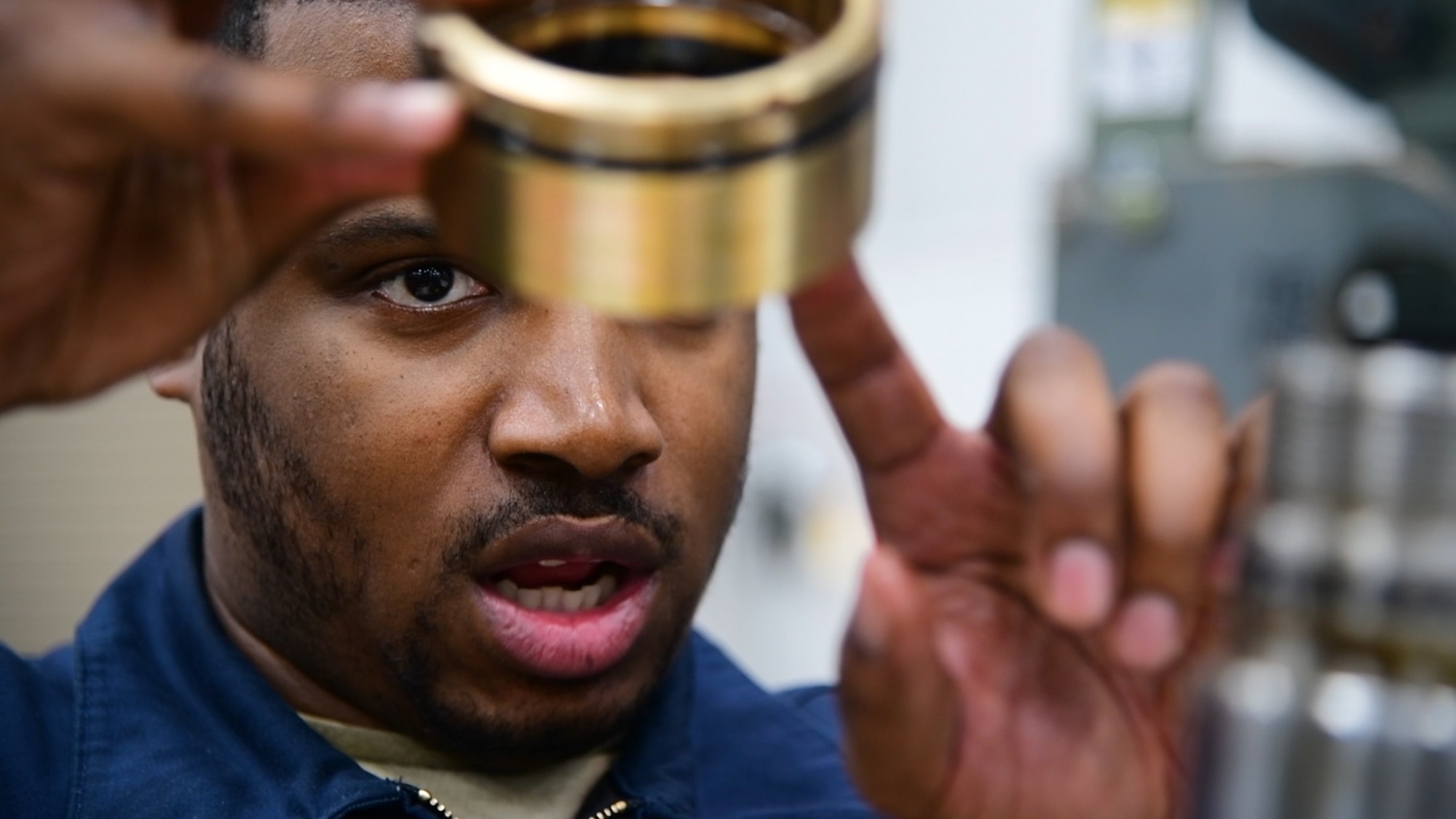 Staff Sgt. Leonard James, 436th Logistic Readiness Squadron vehicle maintenance, inspects a part during a k-loader hydraulic repair at Dover Air Force Base, Del., Jan. 29, 2020. James lost his fiancé and unborn daughter in a 2010 car accident while attending vehicle maintenance technical training. (U.S. Air Force photo by Tech. Sgt. Laura Beckley).