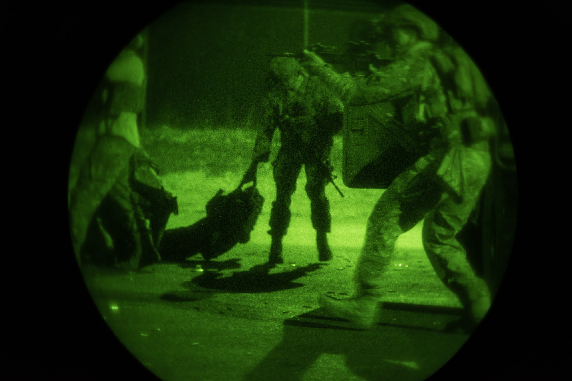 U.S. Airmen from the 148th Air Support Operations Squadron perform a casualty evacuation drill during night-time training
