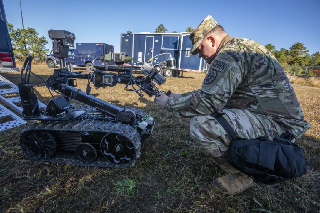 Soldier checks a robot..