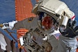 Army astronaut, Col. Andrew Morgan waves in space.