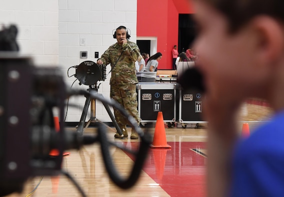 U.S. Air Force Master Sgt. Gilbert Barrera, 338th Training Squadron flight chief, provides Elijah Foley, North Bay Elementary School student, with a radio frequency communications demonstration during the Biloxi Science, Technology, Engineering and Mathematics Night at the Biloxi Junior High School gymnasium, Biloxi, Mississippi, Feb. 11, 2020. The entire Biloxi school district was invited to the event which promoted STEM. Seven career fields from Keesler's 81st Training Wing and the 81st Training Group participated in the event. (U.S. Air Force photo by Kemberly Groue)