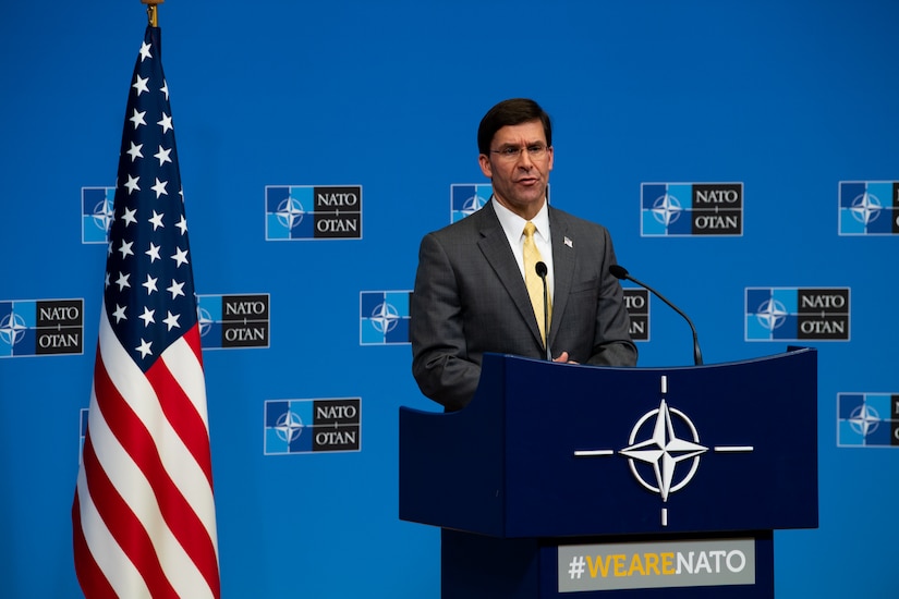 Defense Secretary Dr. Mark T. Esper specks at a podium.