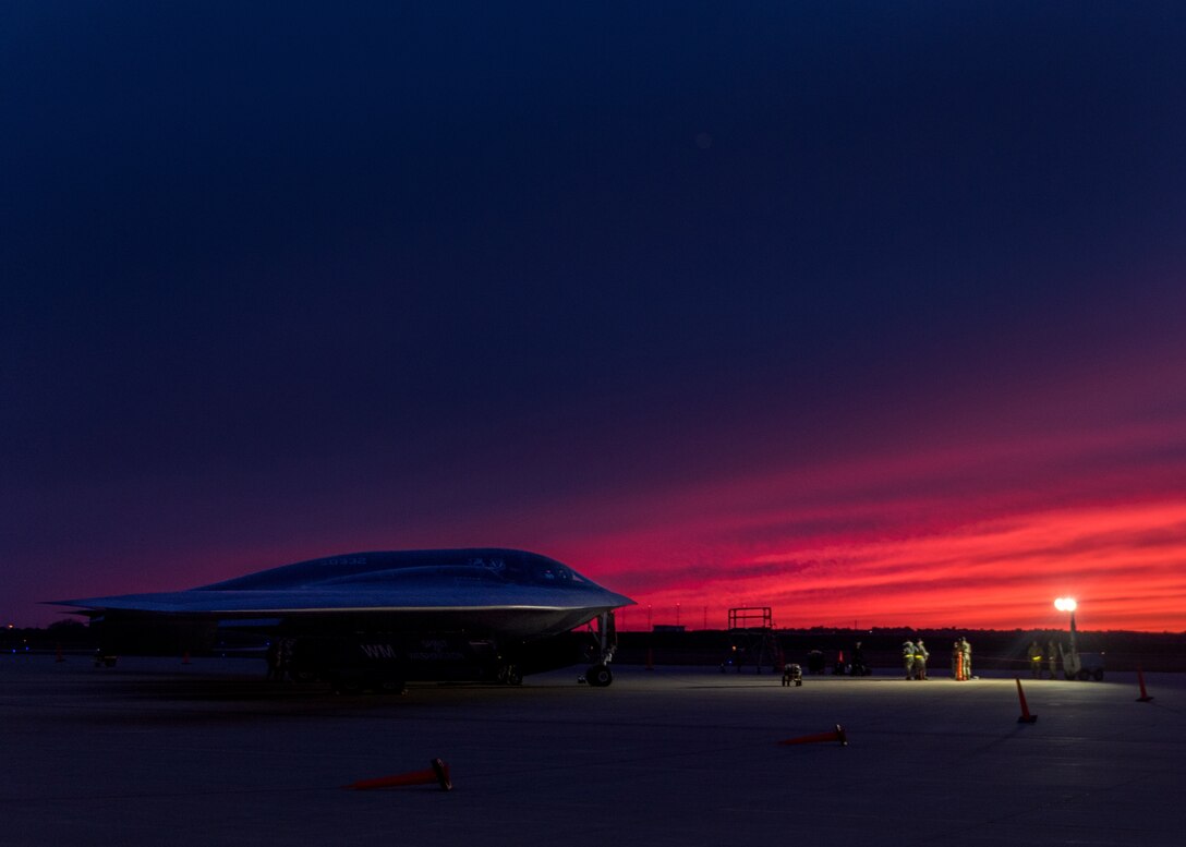 Jet sits on runway in near darkness