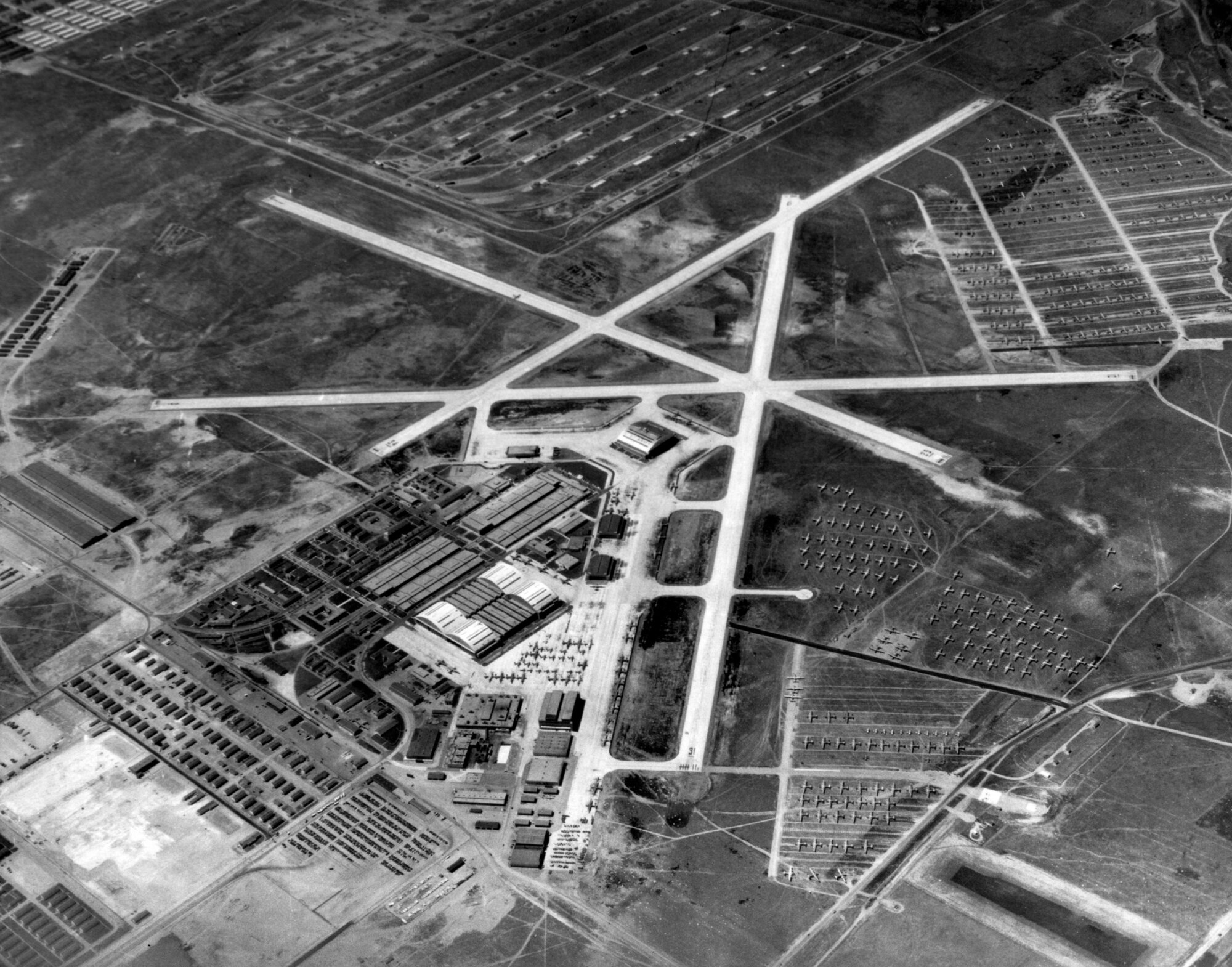 An aerial photo of Hill Field depicting runways, buildings and aircraft.
