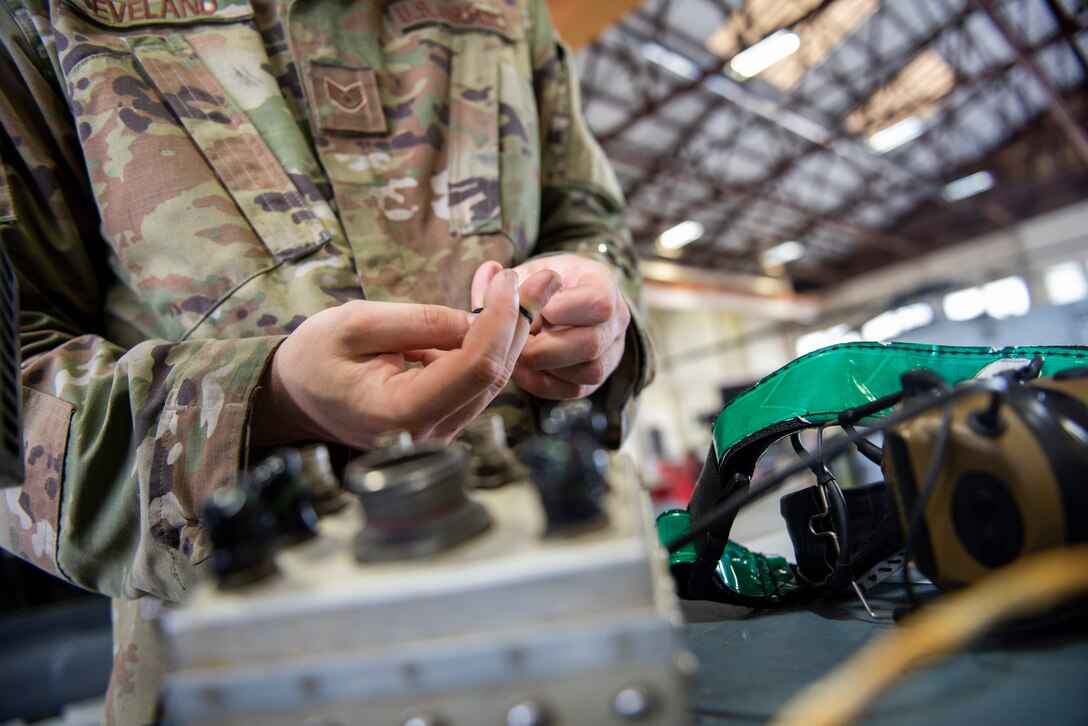 A photo of an Airman covering a relay box