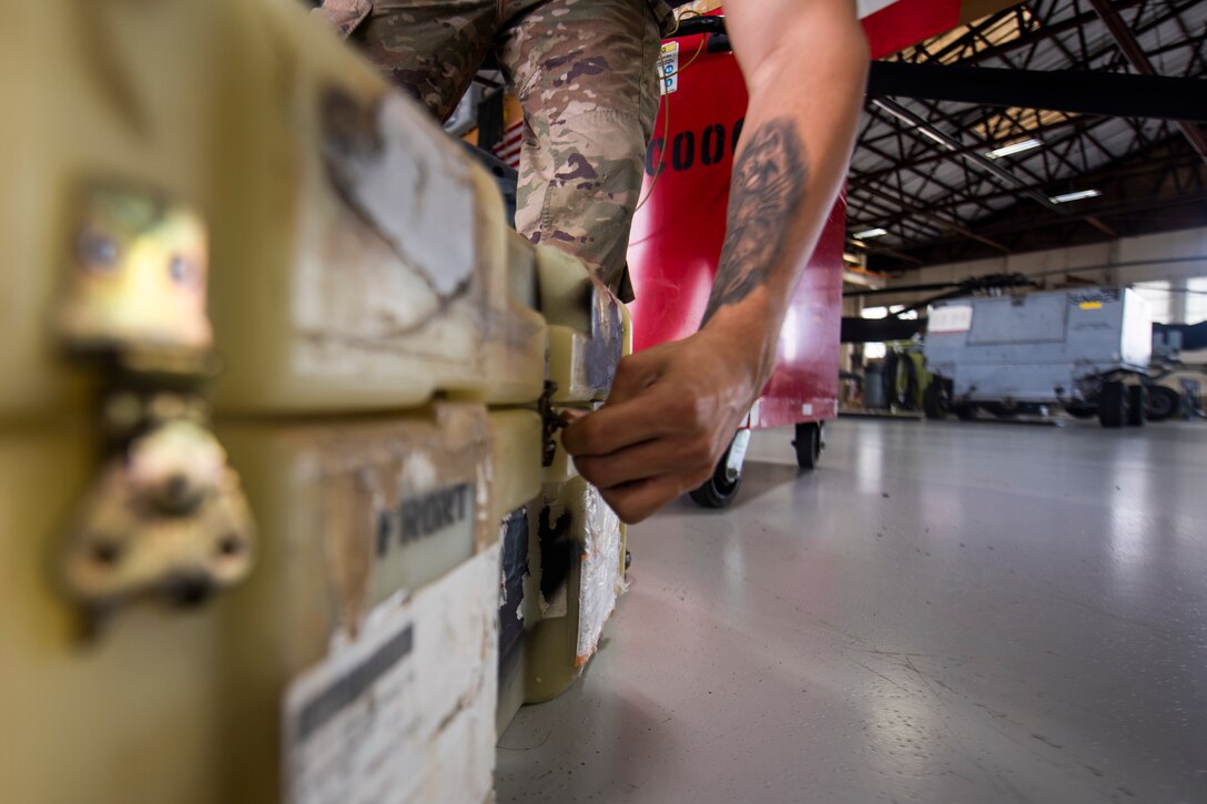 A photo of an Airman closing a box