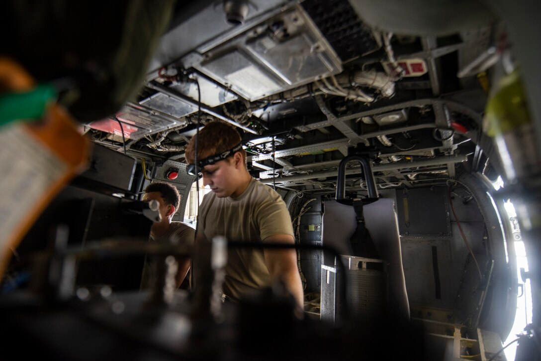 A photo of an Airman checking a helicopter