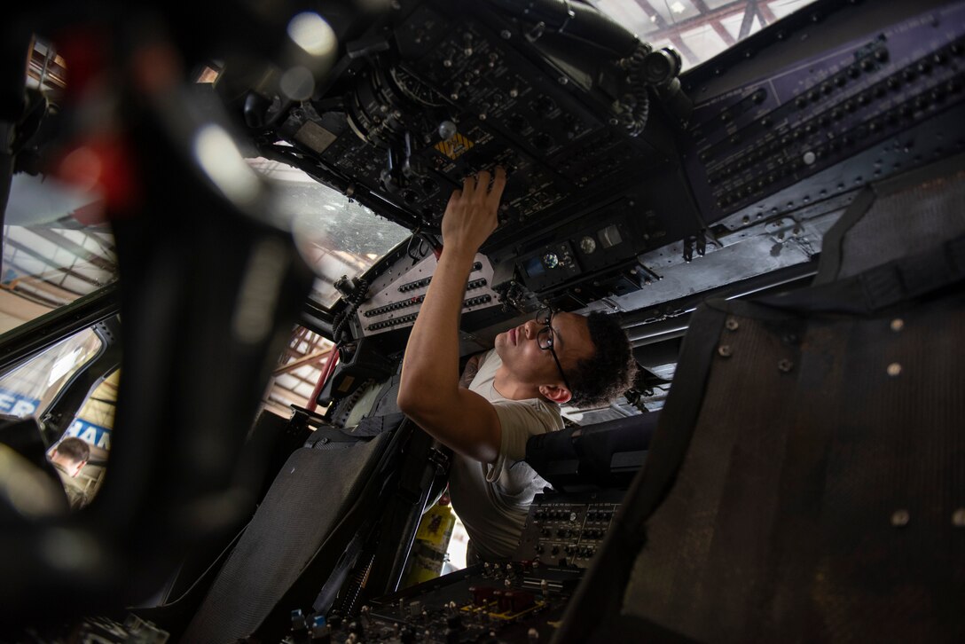 A photo of an Airman flipping a switch