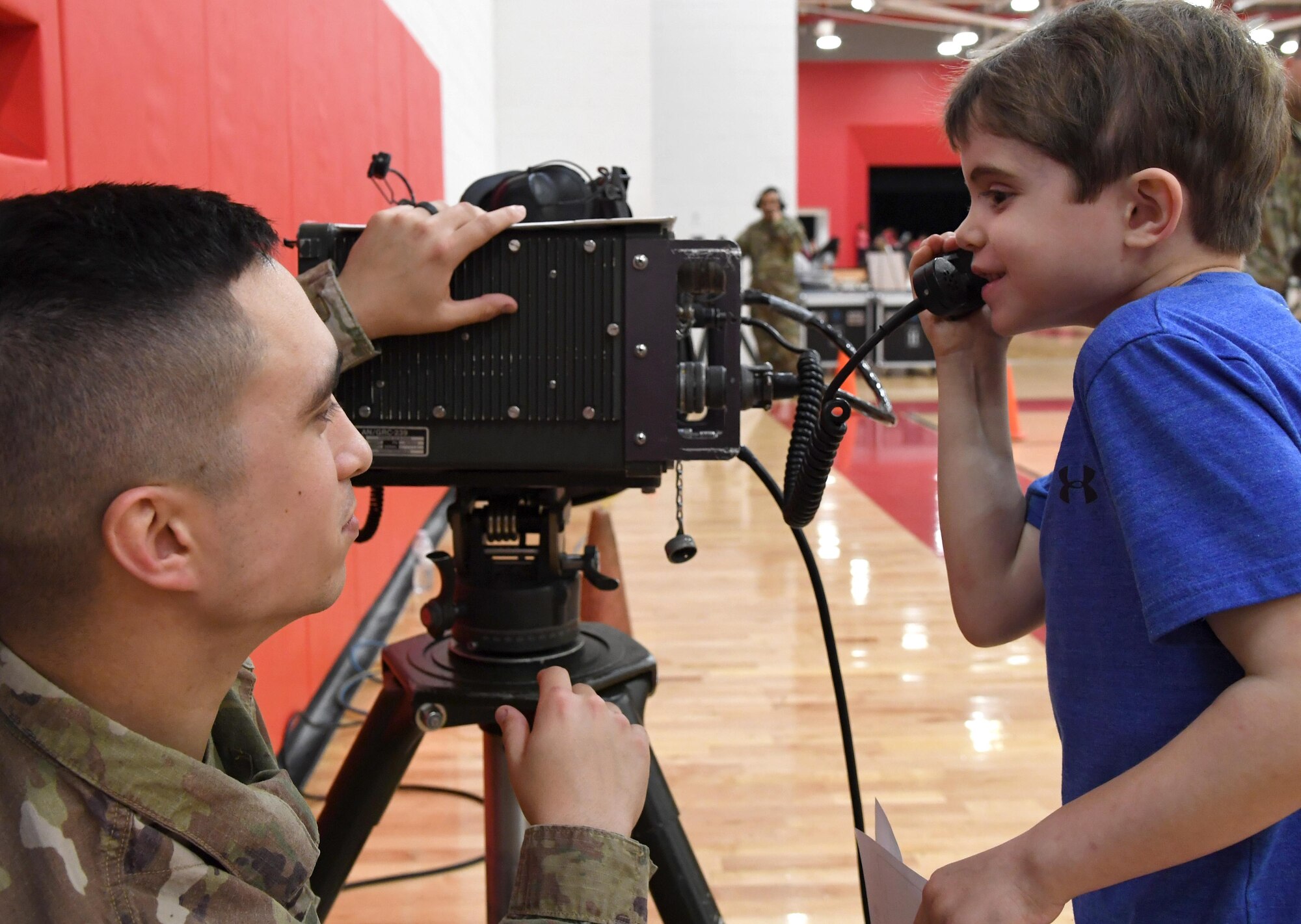 U.S. Air Force Tech. Sgt. John Hoefler, 338th Training Squadron instructor, provides Elijah Foley, North Bay Elementary School student, with a radio frequency communications demonstration during the Biloxi Science, Technology, Engineering and Mathematics Night at the Biloxi Junior High School gymnasium, Biloxi, Mississippi, Feb. 11, 2020. The entire Biloxi school district was invited to the event which promoted STEM. Seven career fields from Keesler's 81st Training Wing and the 81st Training Group participated in the event. (U.S. Air Force photo by Kemberly Groue)