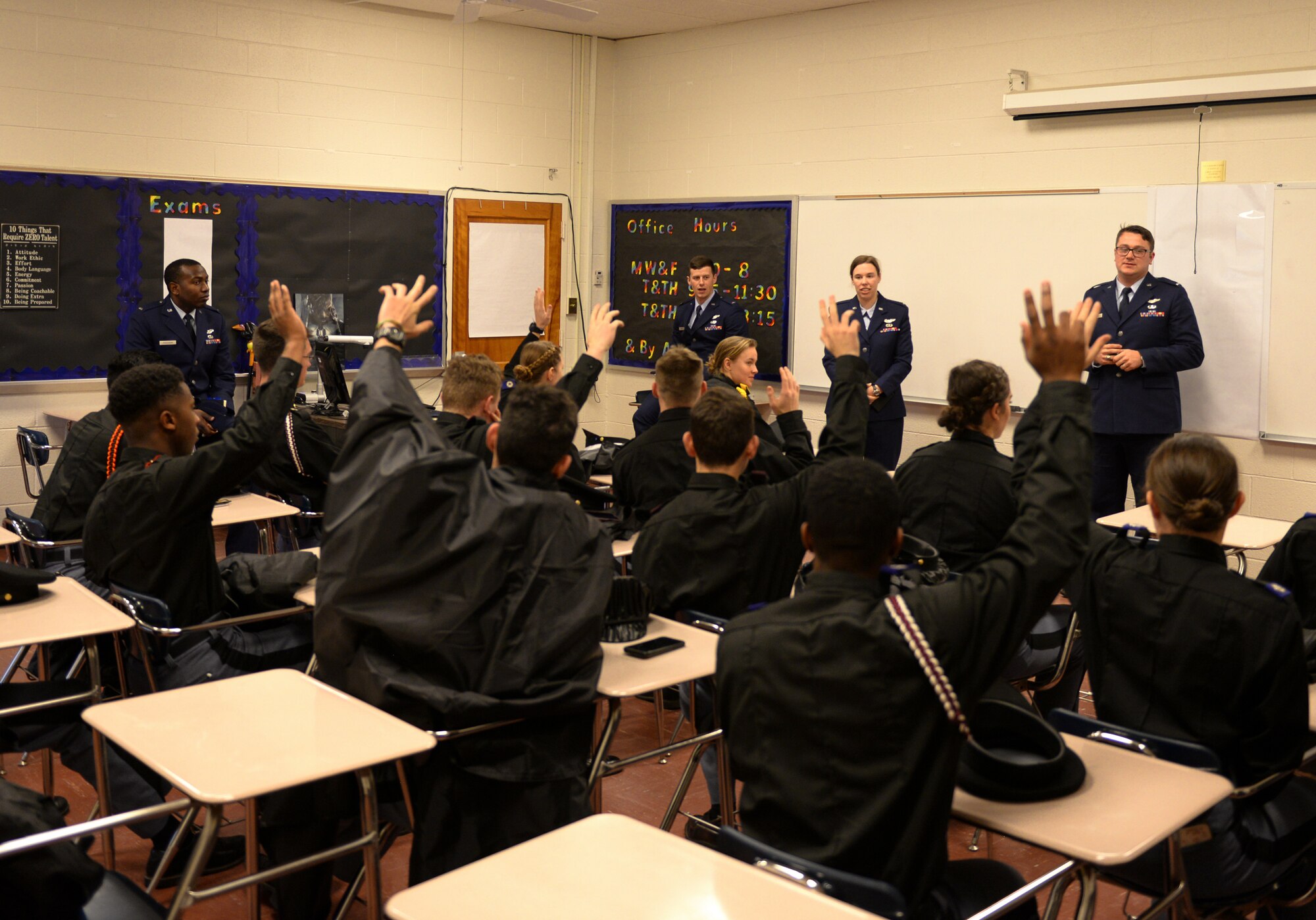 Marion Military Institute cadets raise their hands, while four 14th Flying Training Wing instructor pilots stand in front of them Feb. 10, 2020, at MMI in Marion, Ala. Before raising their hands, the cadets were asked who wanted to be a pilot. (U.S. Air Force photo by Airman Davis Donaldson)