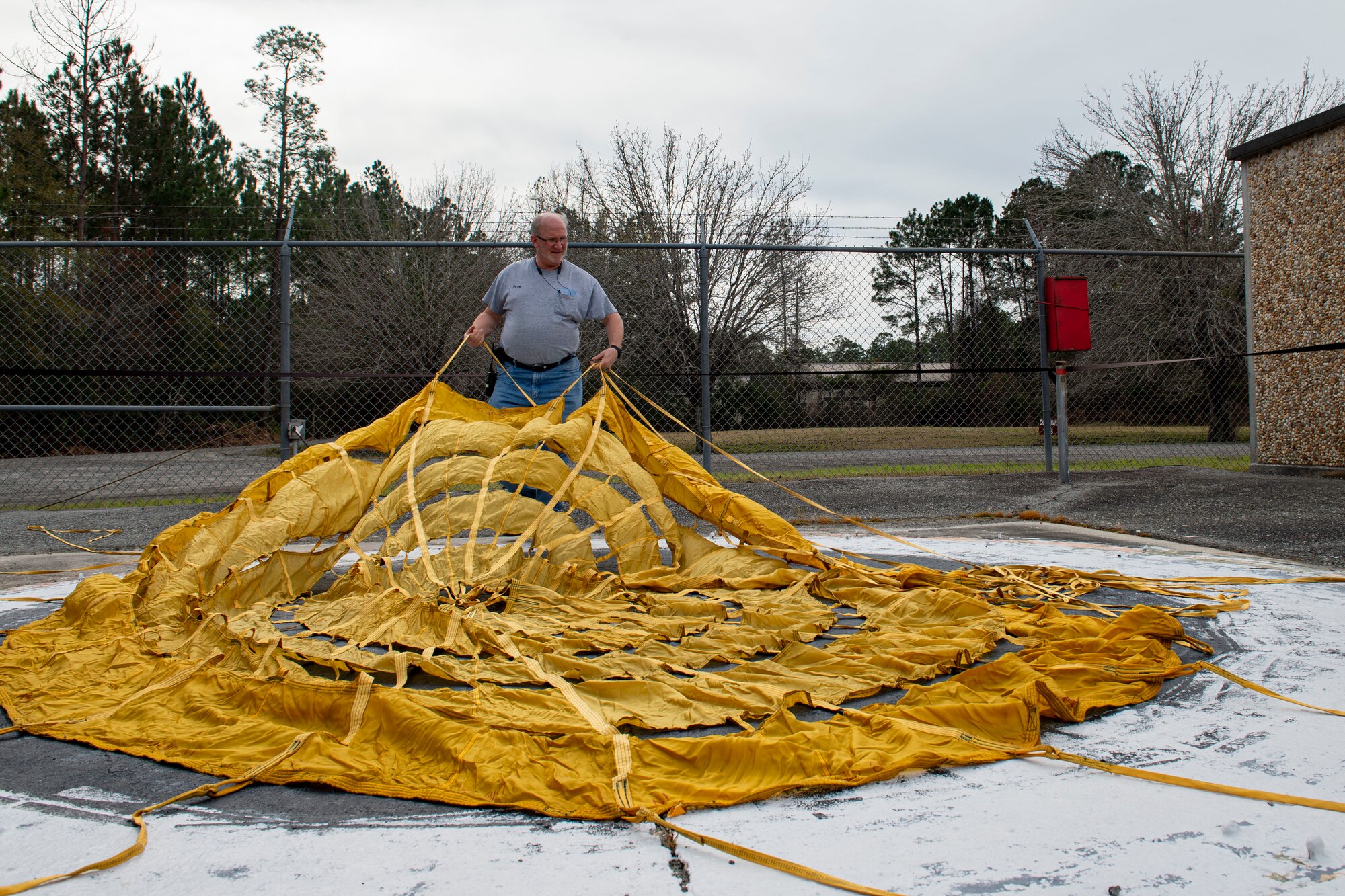 Photo of a range operator moving a drogue parachute.