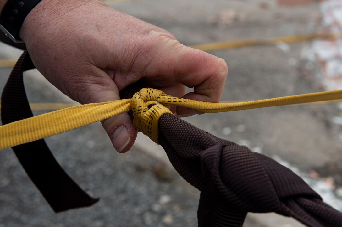 Photo of a range operator securing a drogue parachute.