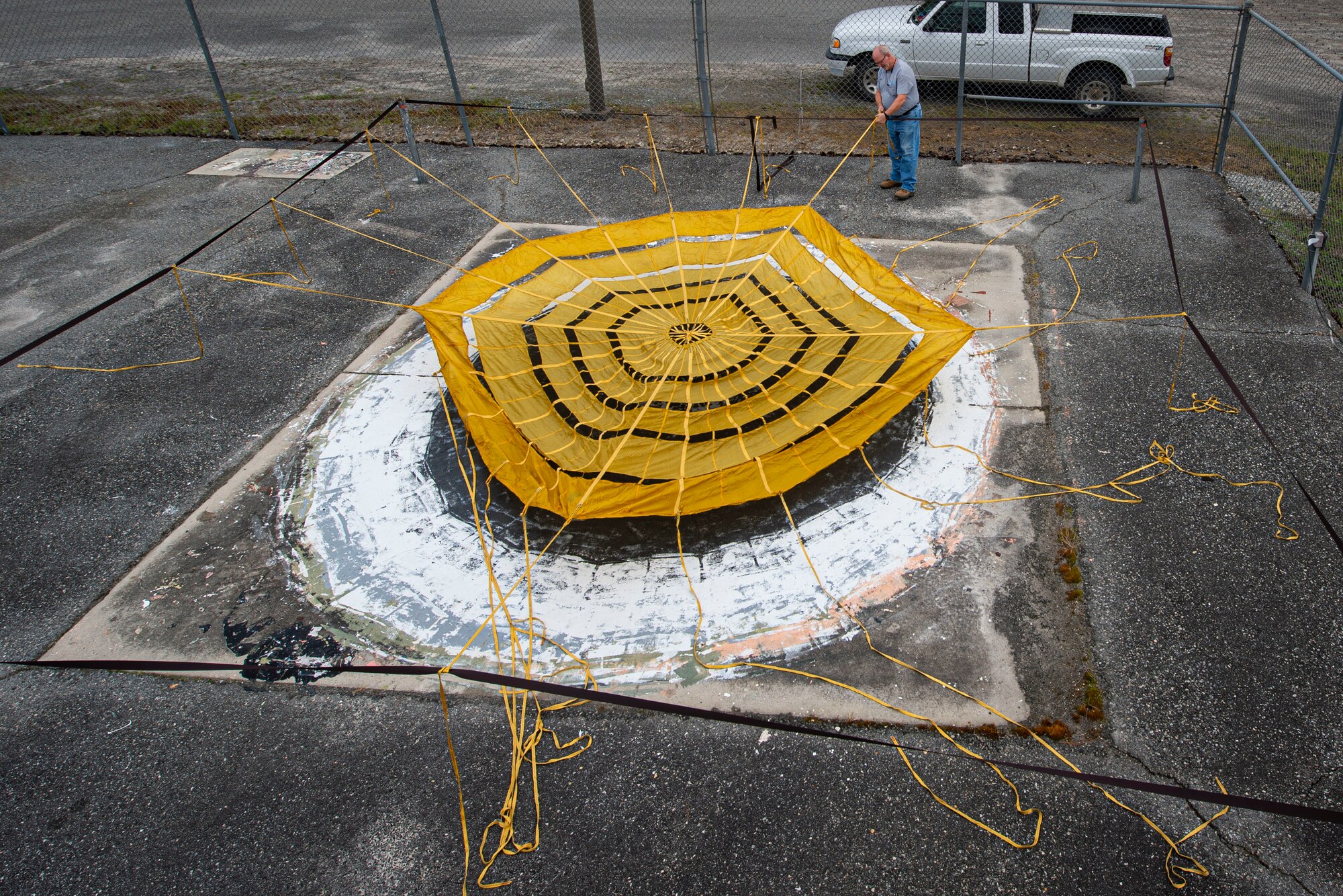 Photo of a range operator preparing to paint a drogue parachute.