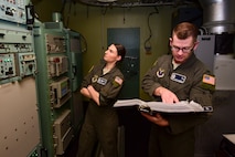 Two Airmen working in a launch facility