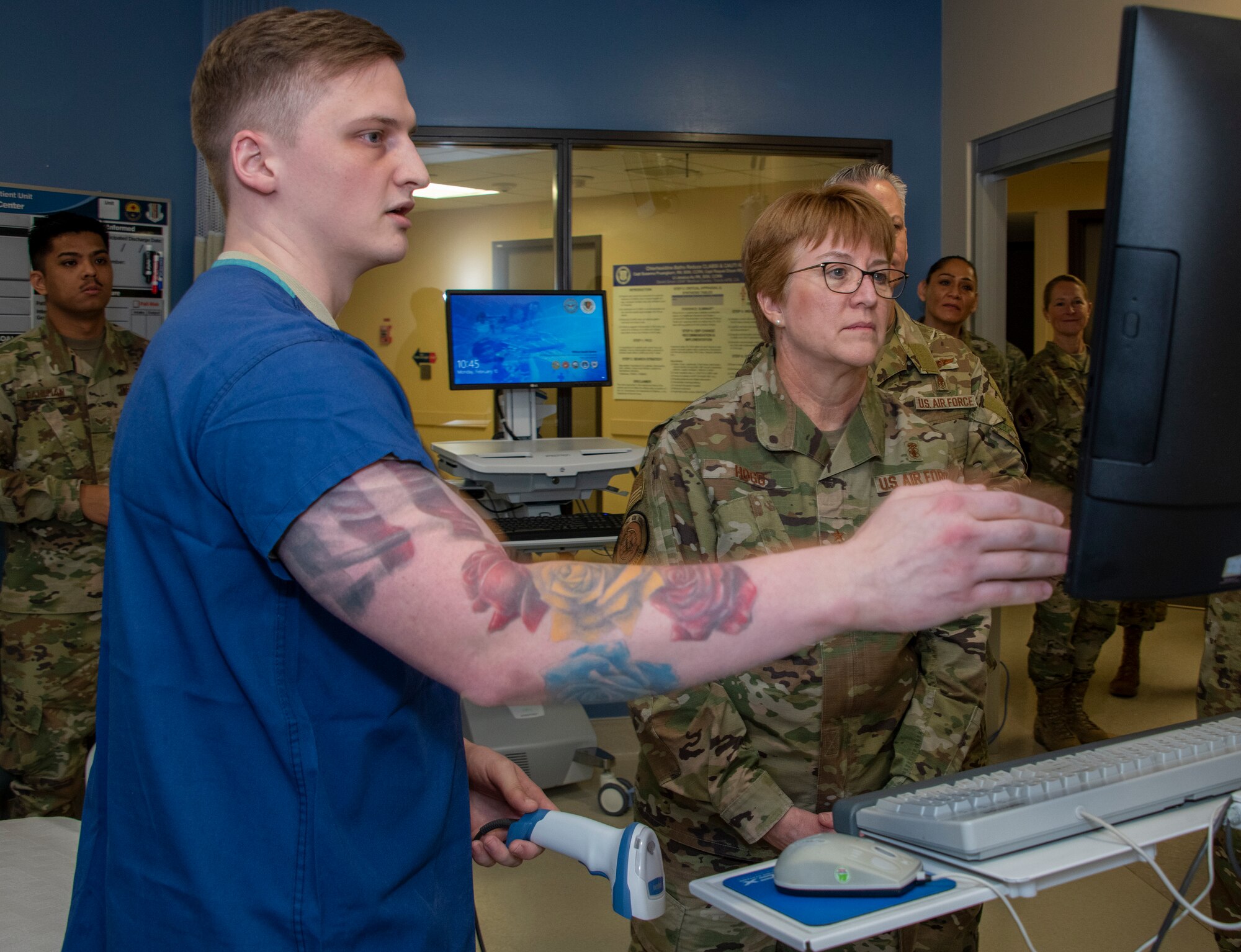 U.S. Air Force Airman 1st Class Trystan Self, left, 60th Inpatient Squadron critical care technician, demonstrates new technology on how information is recorded as Lt. Gen. Dorothy Hogg, Air Force Surgeon General, right, looks on during a tour through the 60th IPTC clinic, David Grant USAF Medical Center at Travis Air Force Base, California, Feb. 10, 2020. Hogg visited with 60th Medical Group Airmen and recognized the positive impact they have on their community through their innovative medical practices. (U.S. Air Force photo by Heide Couch)
