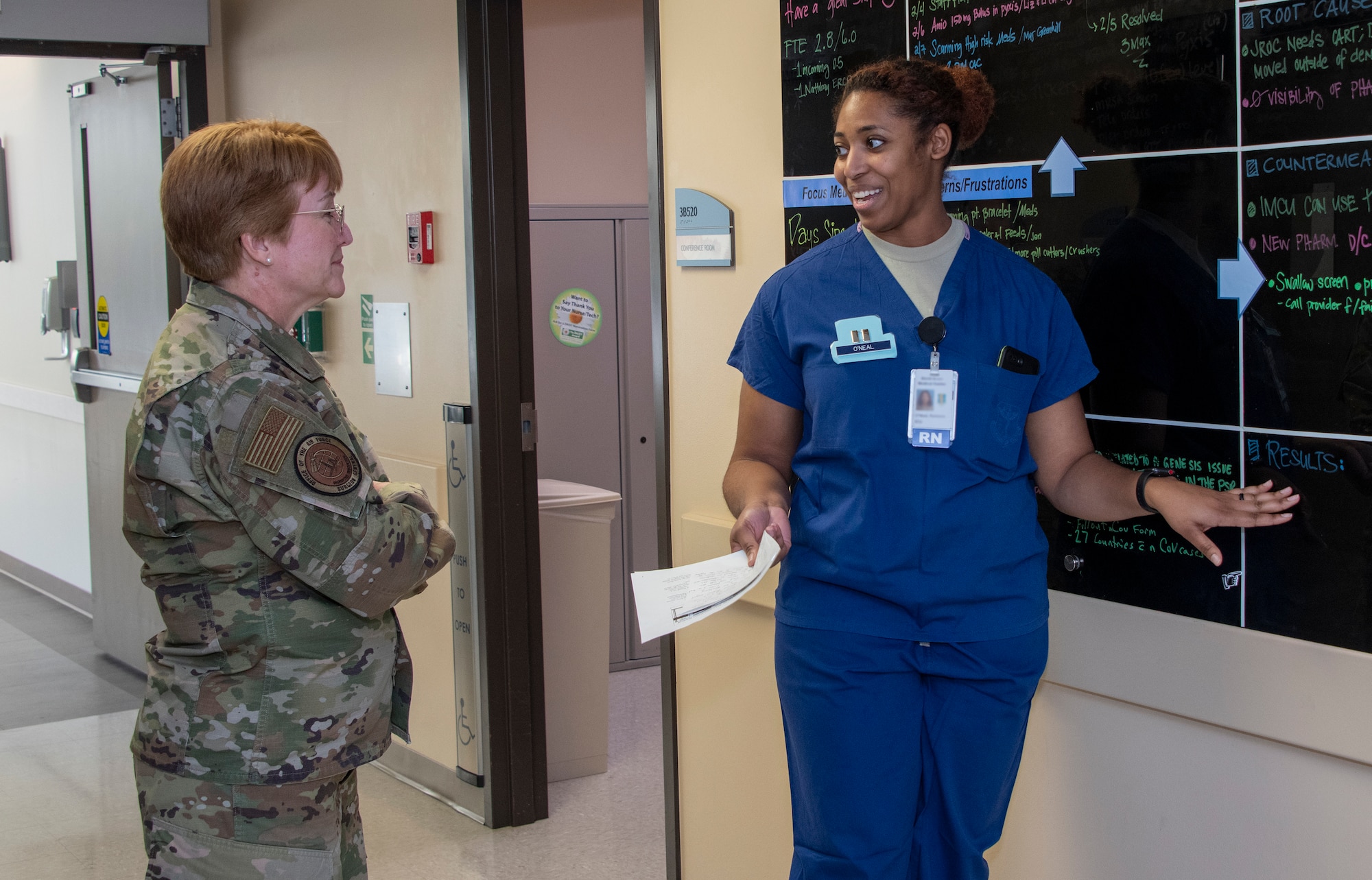 U.S. Air Force Capt. Karessa O’Neal, right, 60th Inpatient Squadron clinical nurse fellow, explains how patients and procedures are tracked on a situation board while Lt. Gen. Dorothy Hogg, Air Force Surgeon General, left, looks on during a tour of the 60th IPTC clinic, David Grant USAF Medical Center at Travis Air Force Base, California, Feb. 10, 2020. Hogg visited with 60th Medical Group Airmen and recognized the positive impact they have on their community through their innovative medical practices. (Photo altered for security reasons) (U.S. Air Force photo by Heide Couch