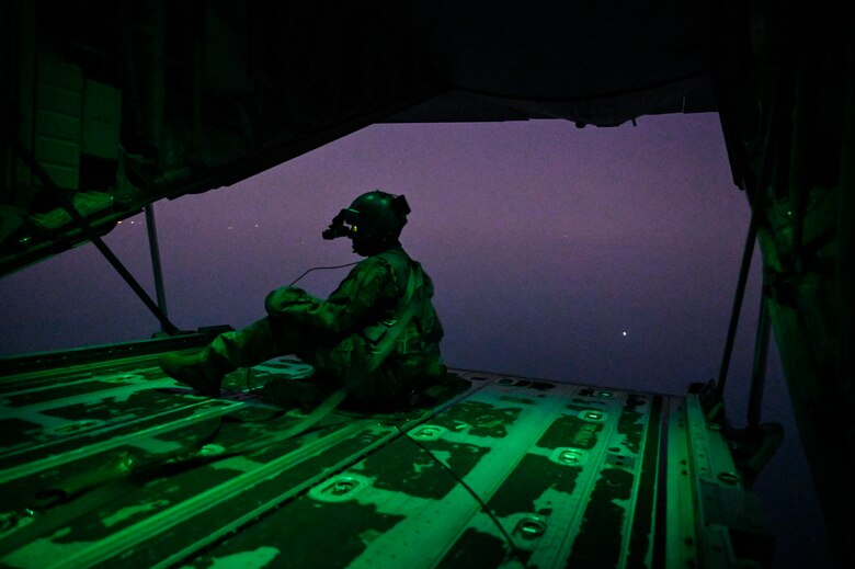 A U.S. Air Force HC-130J Combat King II loadmaster with the 79th Expeditionary Rescue Squadron, deployed to Al Udeid Air Base, Qatar, observes airspace during a personnel recovery training mission over the Arabian Gulf, Feb. 6, 2020.