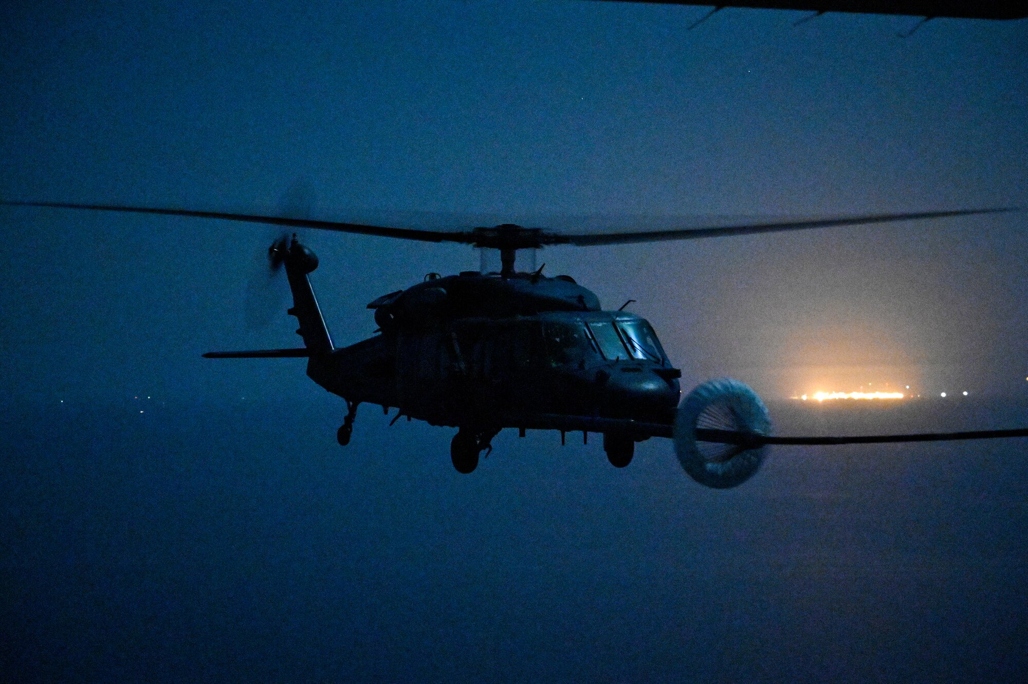 A U.S. Air Force HH-60G Pave Hawk, assigned to the 66th Expeditionary Rescue Squadron deployed to Al Udeid Air Base, Qatar, conducts a helicopter in-air refueling over the Arabian Gulf with a U.S. Air Force HC-130J Combat King II, assigned to the 79th ERQS deployed to Al Udeid AB, Feb. 6, 2020.
