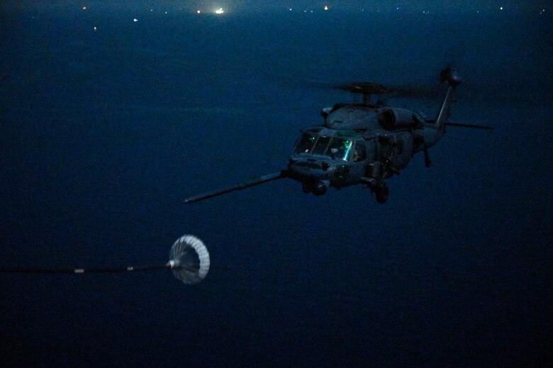A U.S. Air Force HH-60G Pave Hawk, assigned to the 66th Expeditionary Rescue Squadron deployed to Al Udeid Air Base, Qatar, conducts a helicopter in-air refueling over the Arabian Gulf with a U.S. Air Force HC-130J Combat King II, assigned to the 79th ERQS deployed to Al Udeid AB, Feb. 6, 2020.