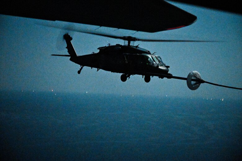 A U.S. Air Force HH-60G Pave Hawk, assigned to the 66th Expeditionary Rescue Squadron deployed to Al Udeid Air Base, Qatar, conducts a helicopter in-air refueling over the Arabian Gulf with a U.S. Air Force HC-130J Combat King II, assigned to the 79th ERQS deployed to Al Udeid AB, Feb. 6, 2020.