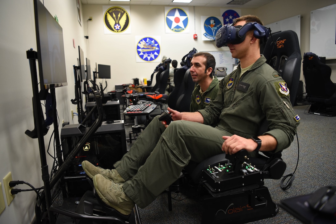 Second Lt. Matthew Demarco, 14th Student Squadron student pilot, operates the virtual reality flight simulation equipment while Lt. Col. Christopher Harris, 41st Flying Training Squadron chief pilot and director of innovation flight, instructs him Feb. 11, 2020, on Columbus Air Force Base, Miss. In the VR simulation students can practice everything from starting up the aircraft to landing it. The ability to use VR tools extends the students familiarity with the aircraft they are going to fly before they step foot in it. (U.S. Air Force photo by Airman 1st Class Jake Jacobsen)