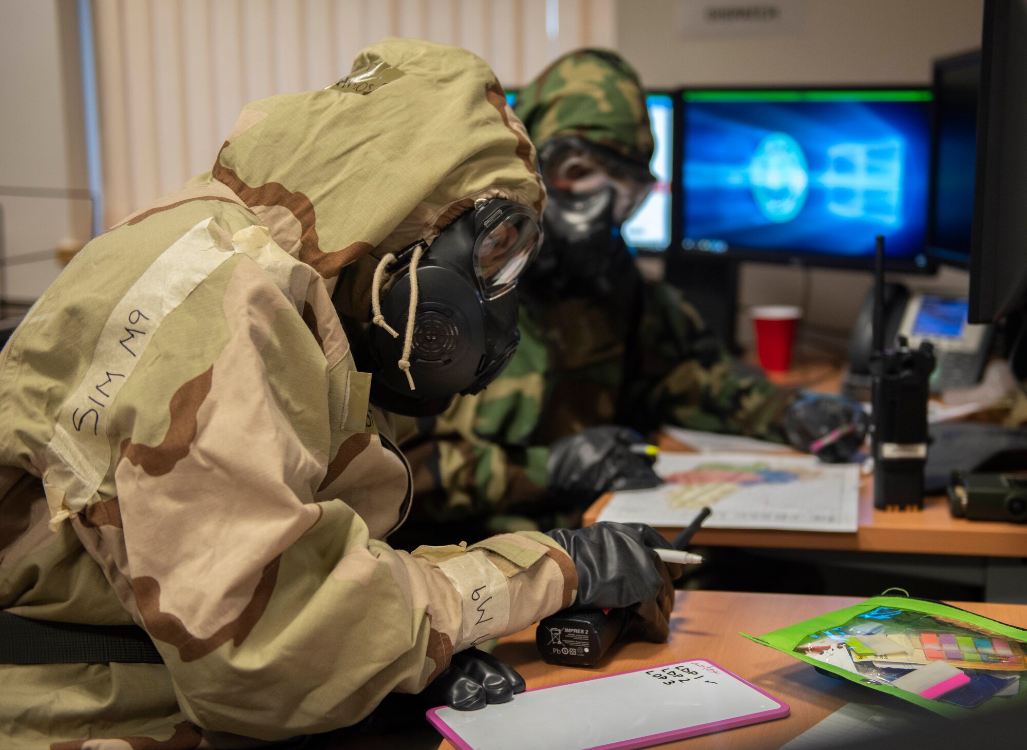 A 100th Air Refueling Wing Airman in chemical, biological, radiological, nuclear and explosive protective gear plans cordon procedures during a readiness exercise at RAF Mildenhall, England, Feb. 10, 2020. The exercise was performed to test the Bloody Hundredth and sharpen their response and readiness abilities. (U.S. Air Force photo by Staff Sgt. Luke Milano)