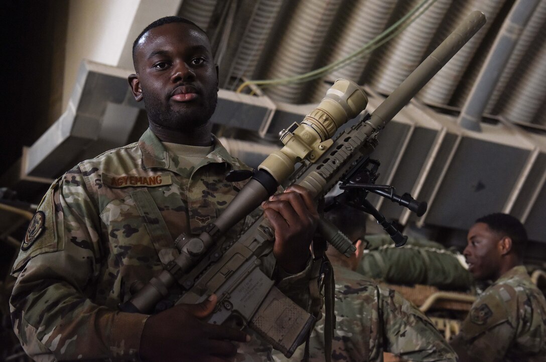 U.S. Air Force Staff Sgt. Yaw Agyemang from the 379th Expeditionary Civil Engineering Squadron, poses with a rifle during a mission orientation brief at Al Udeid Air Base, Qatar on Feb. 8, 2020. The 379th Expeditionary Operations Group held the mission orientation day to give service members a more in-depth look at how AUAB supports the U.S. Air Forces Central Command mission. (U.S. Air Force photo by Senior Airman Shay Stuart)