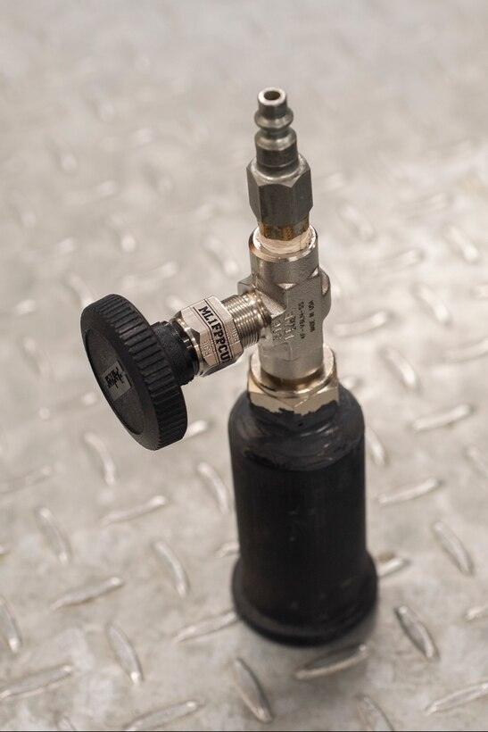 The Pressurized Leak Detection Cup sits on a table Feb. 14, 2020, at RAF Mildenhall, England. Designed by Staff Sgt. Patrick Leach, 100th Maintenance Squadron aircraft fuels systems craftsman, the device reduces the time needed to detect leaks within the fuel tanks of KC-135 Stratotankers. (U.S. Air Force photo by Airman 1st Class Joseph Barron)