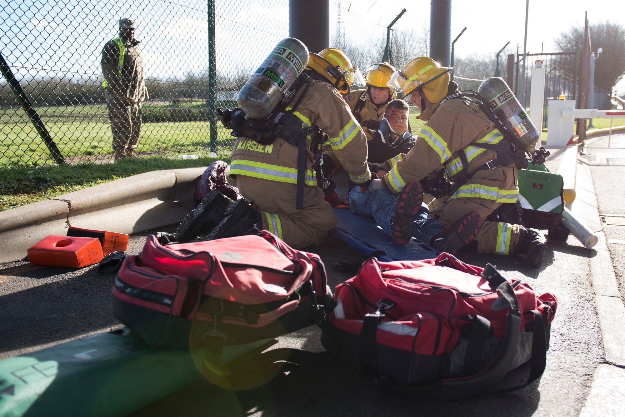 422nd Civil Engineer Squadron firefighters assist a simulated casualty during the 501st Combat Support Wing Readiness Exercise 20-01 at RAF Croughton, England, Feb. 12, 2020. The exercise tested the wing’s preparedness and response capabilities to an emergency situation. (U.S. Air Force photo by Airman 1st Class Jennifer Zima)