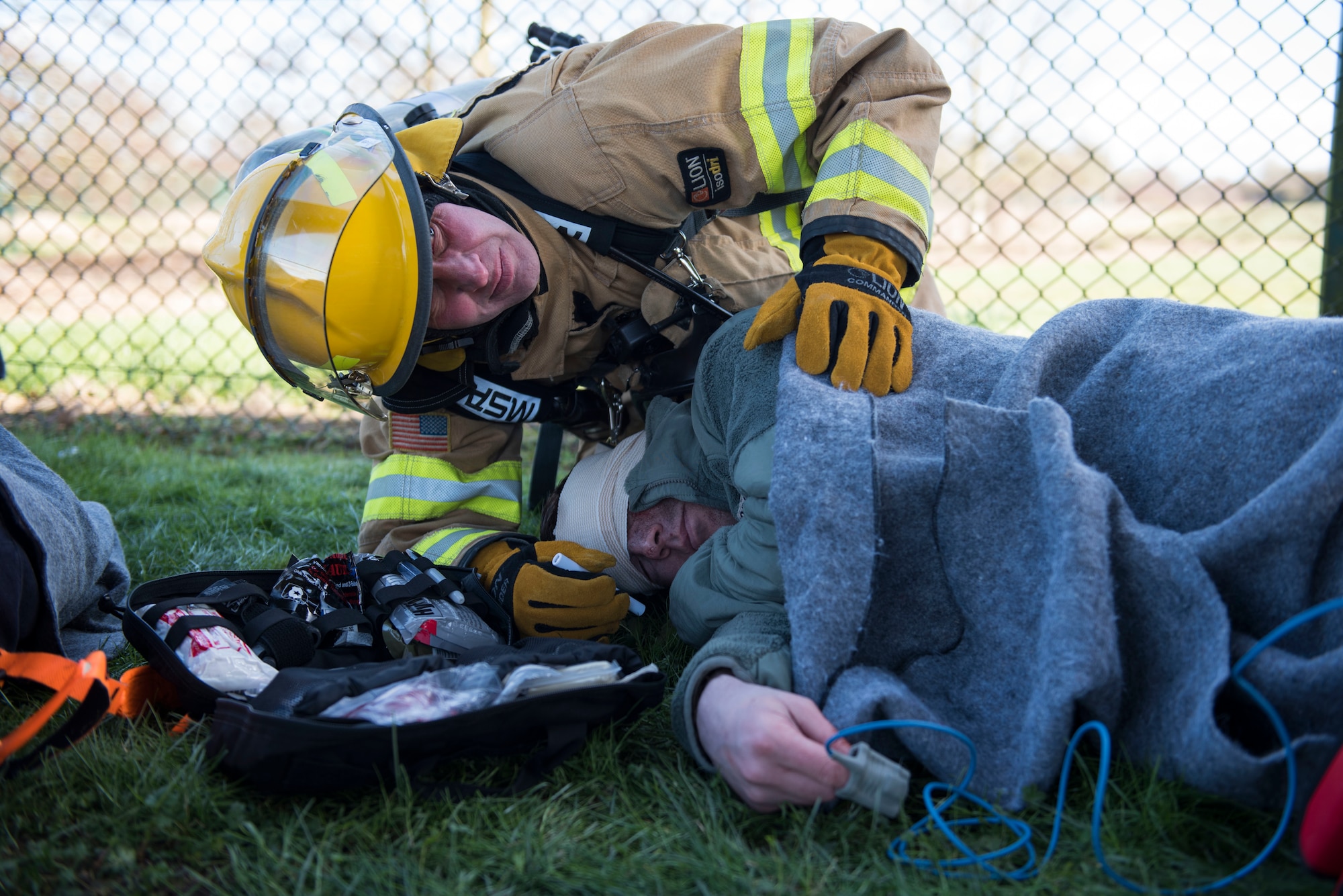Craig Marsden, 422nd Civil Engineer Squadron firefighter, assists a simulated casualty during the 501st Combat Support Wing Readiness Exercise 20-01 at RAF Croughton, England, Feb. 12, 2020. The exercise tested the wing’s preparedness and response capabilities to an emergency situation. (U.S. Air Force photo by Airman 1st Class Jennifer Zima)