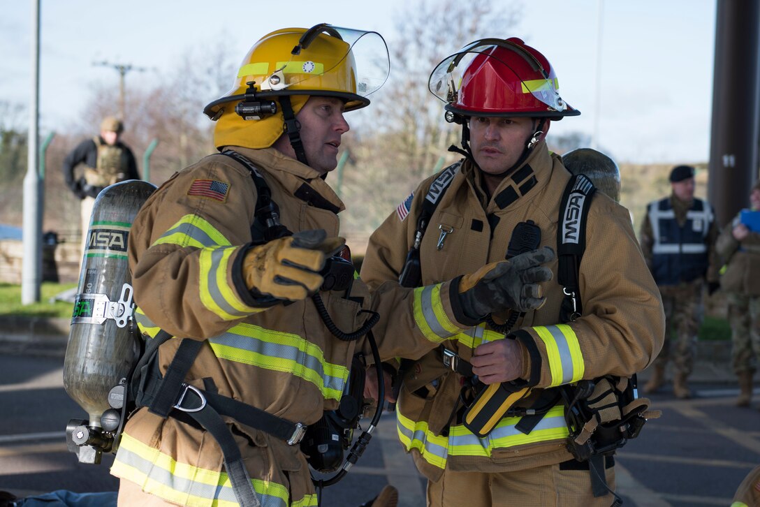 Phillip Semper, 422nd Civil Engineer Squadron firefighter, and Michael Davy, 422nd CES firefighter crew chief, discuss the next steps during the 501st Combat Support Wing Readiness Exercise 20-01 at RAF Croughton, England, Feb. 12, 2020. The exercise tested the wing’s preparedness and response capabilities to an emergency situation. (U.S. Air Force photo by Airman 1st Class Jennifer Zima)