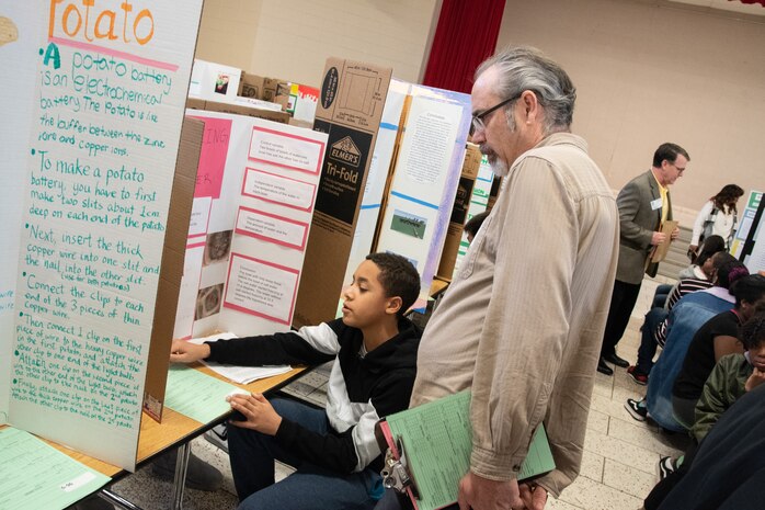 Barry Hodges, technical manager and chemist with the Environmental Protection and Utilities Branch at the U.S. Army Engineering and Support Center, Huntsville, interviews a sixth-grade student during Williams Middle School’s science fair in Huntsville, Alabama, Jan. 30, 2020. Nearly 200 sixth-, seventh- and eighth-graders presented projects at the school’s fair.