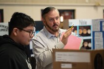 Mark Reed, contract specialist and former science teacher, talks to a sixth-grade student about his project during Williams Middle School’s science fair in Huntsville, Alabama, Jan. 30, 2020. Nearly 200 sixth-, seventh- and eighth-graders presented projects at the school’s fair. Reed was one of six volunteers from the U.S. Army Engineering and Support Center, Huntsville, at the event.