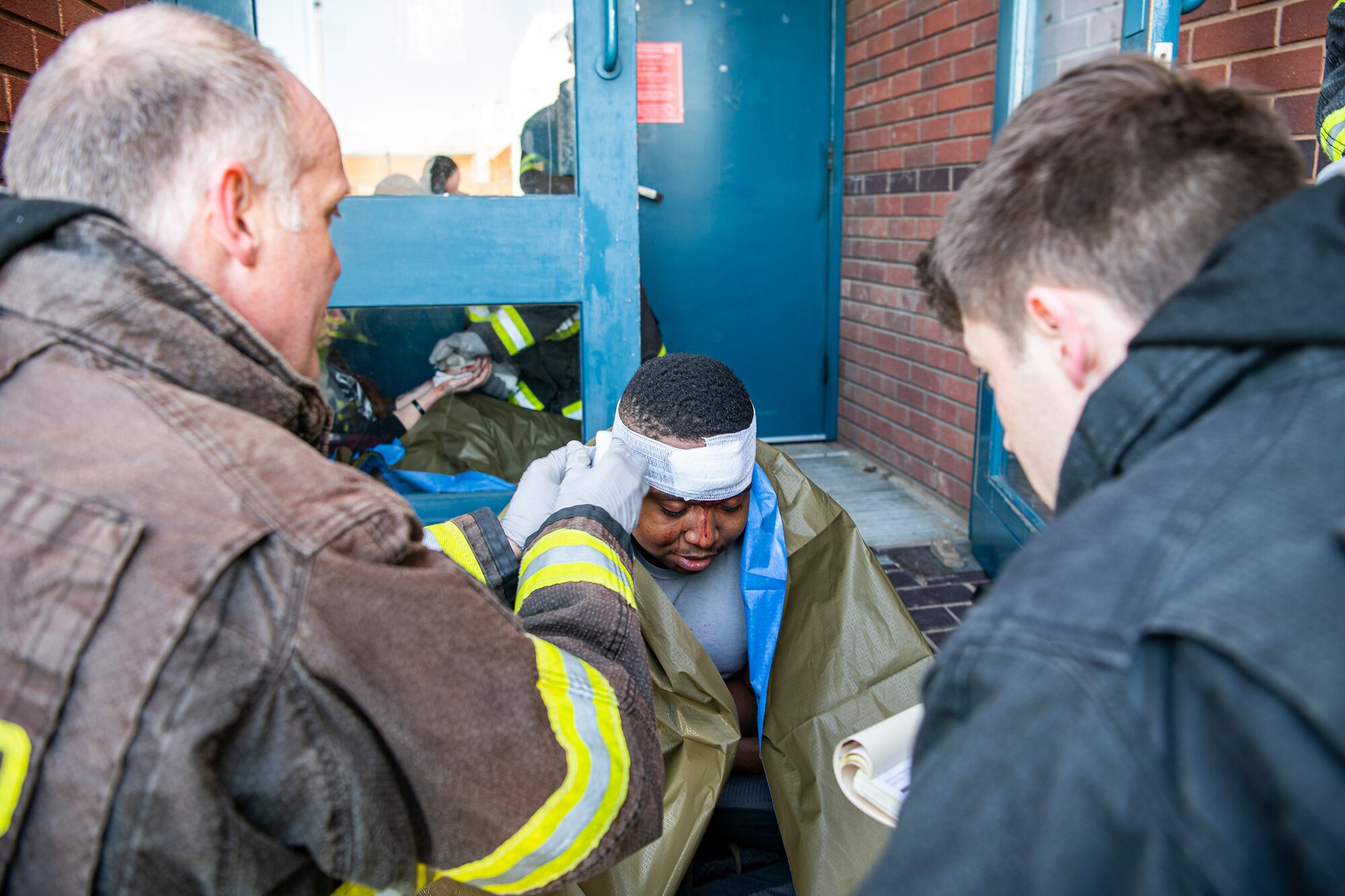 Firefighters from the 423d Civil Engineer Squadron, tend to a simulated victim during a readiness exercise, at RAF Molesworth, England, Feb. 11, 2020. The exercise tested the wing’s preparedness and response capabilities to an emergency situation. (U.S. Air Force photo by Senior Airman Eugene Oliver)