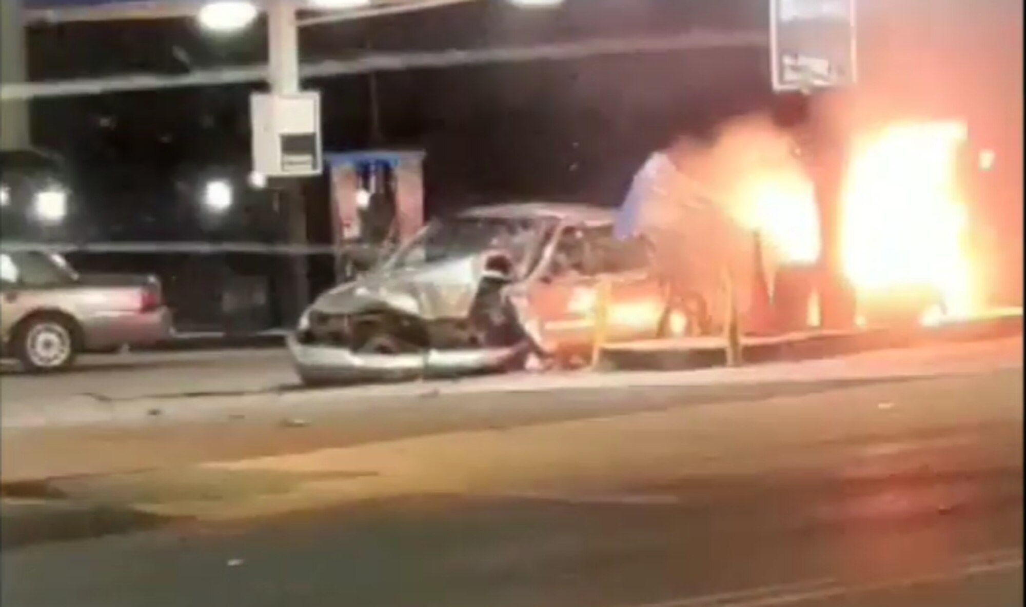 A wrecked car sits next to a burning fuel pump in Birmingham, Alabama, Jan. 9, 2020.