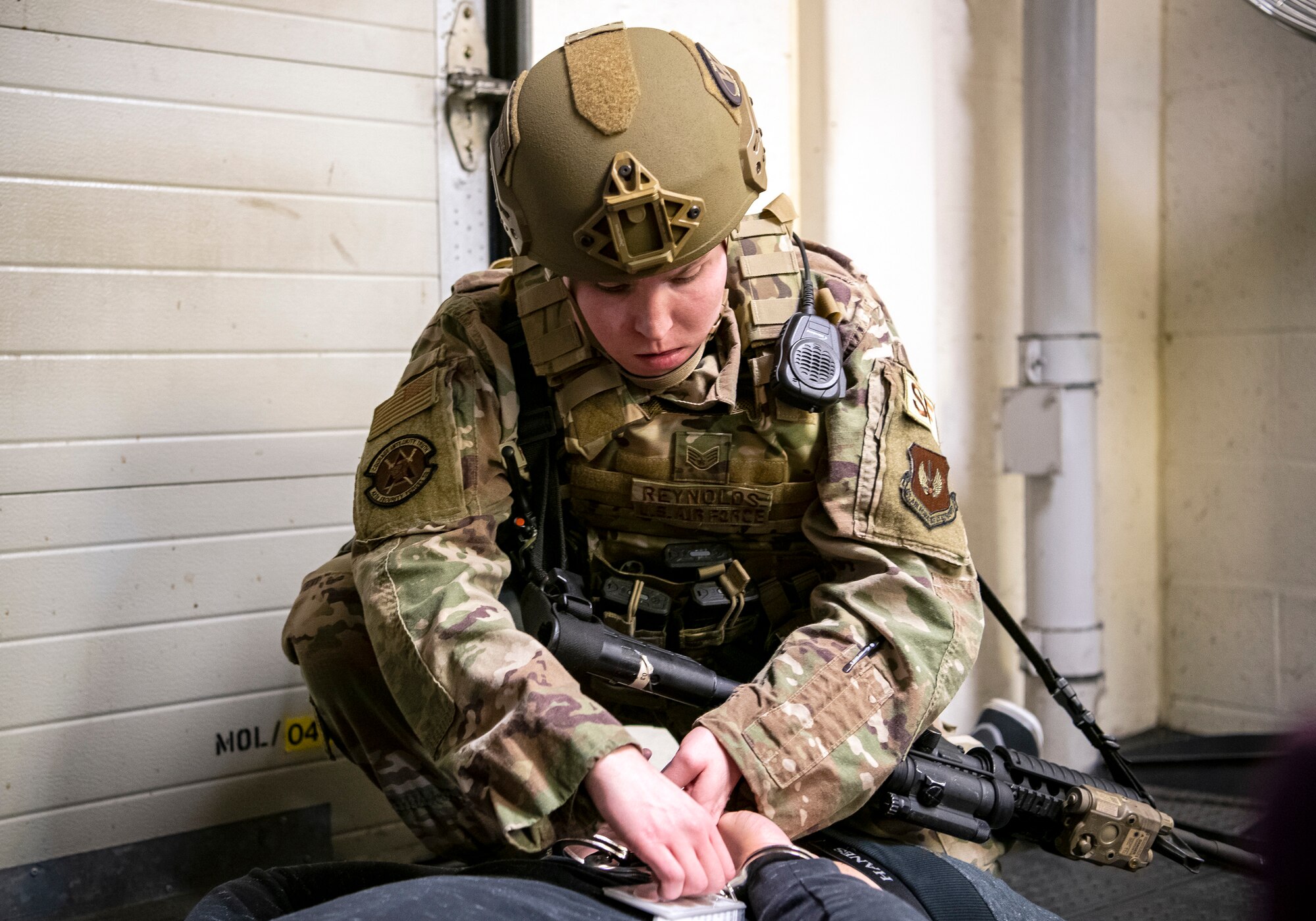 Staff Sgt. Chelsea Reynolds, 423d Security Forces Squadron flight sergeant, handcuffs a simulated suspect during a readiness exercise, at RAF Molesworth, England, Feb. 11, 2020. The exercise tested the wing’s preparedness and response capabilities to an emergency situation. (U.S. Air Force photo by Senior Airman Eugene Oliver)