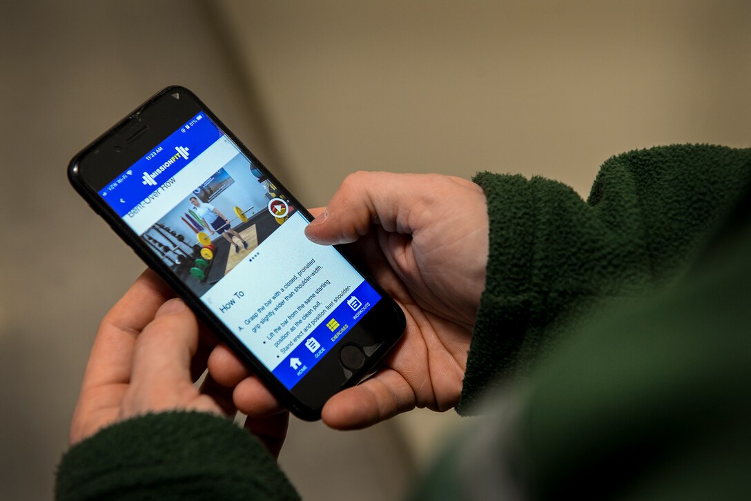 A smartphone user navigates the Defense Health Agency’s newest health and wellness app, Air Force MissionFit, at Hanscom Air Force Base, Mass., Feb. 13. The app offers a 12-week program of exercise routines along with a library of more than 90 exercises and detailed instructions with video, images and text. (U.S. Air Force photo by Lauren Russell)