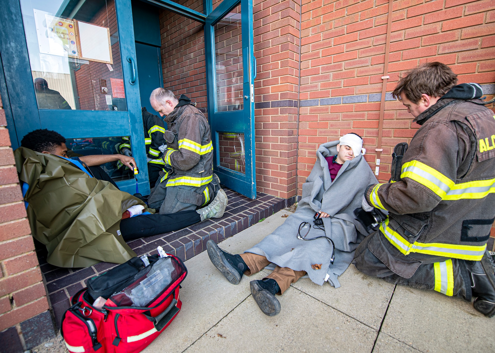 Firefighters from the 422d Civil Engineer Squadron, tend to simulated victims during a readiness exercise, at RAF Molesworth, England, Feb. 11, 2020. The exercise tested the wing’s preparedness and response capabilities to an emergency situation. (U.S. Air Force photo by Senior Airman Eugene Oliver)