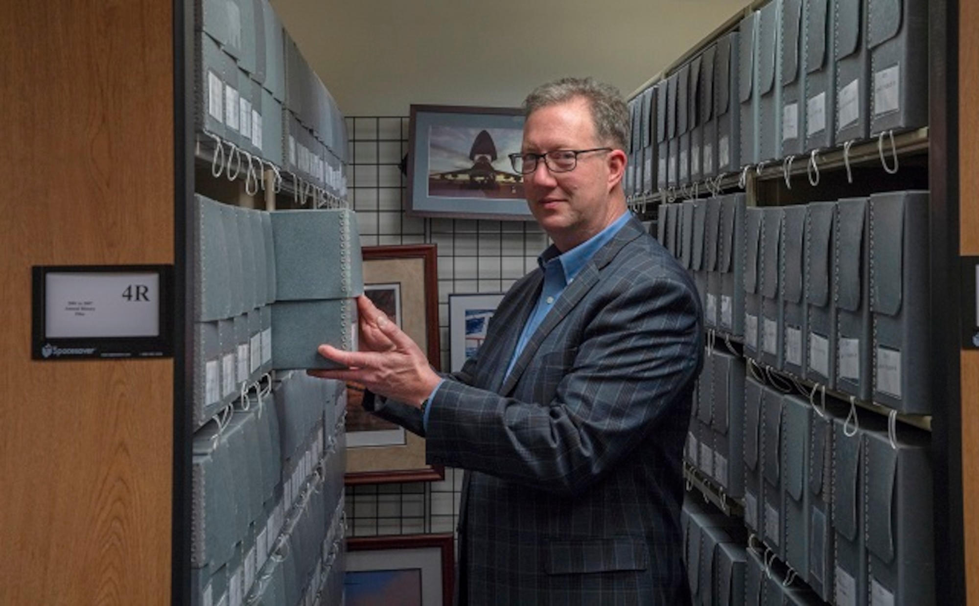 U.S. Transportation Command Historian Dr. Joseph Mason is pictured reviewing archived historical documents in the organization’s History Office, Feb. 11, 2020.