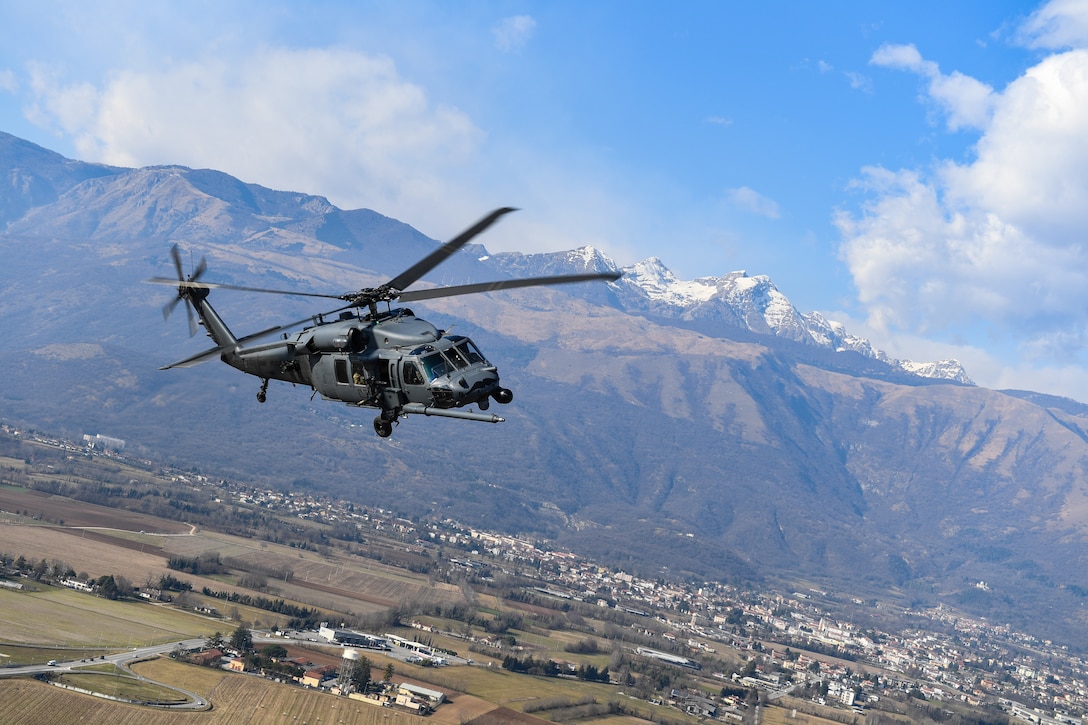 An HH-60G Pave Hawk helicopter flies over Aviano Air Base