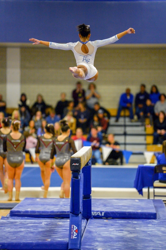 Air Force Academy cadet performs on a balance beam during a gymnastics meet