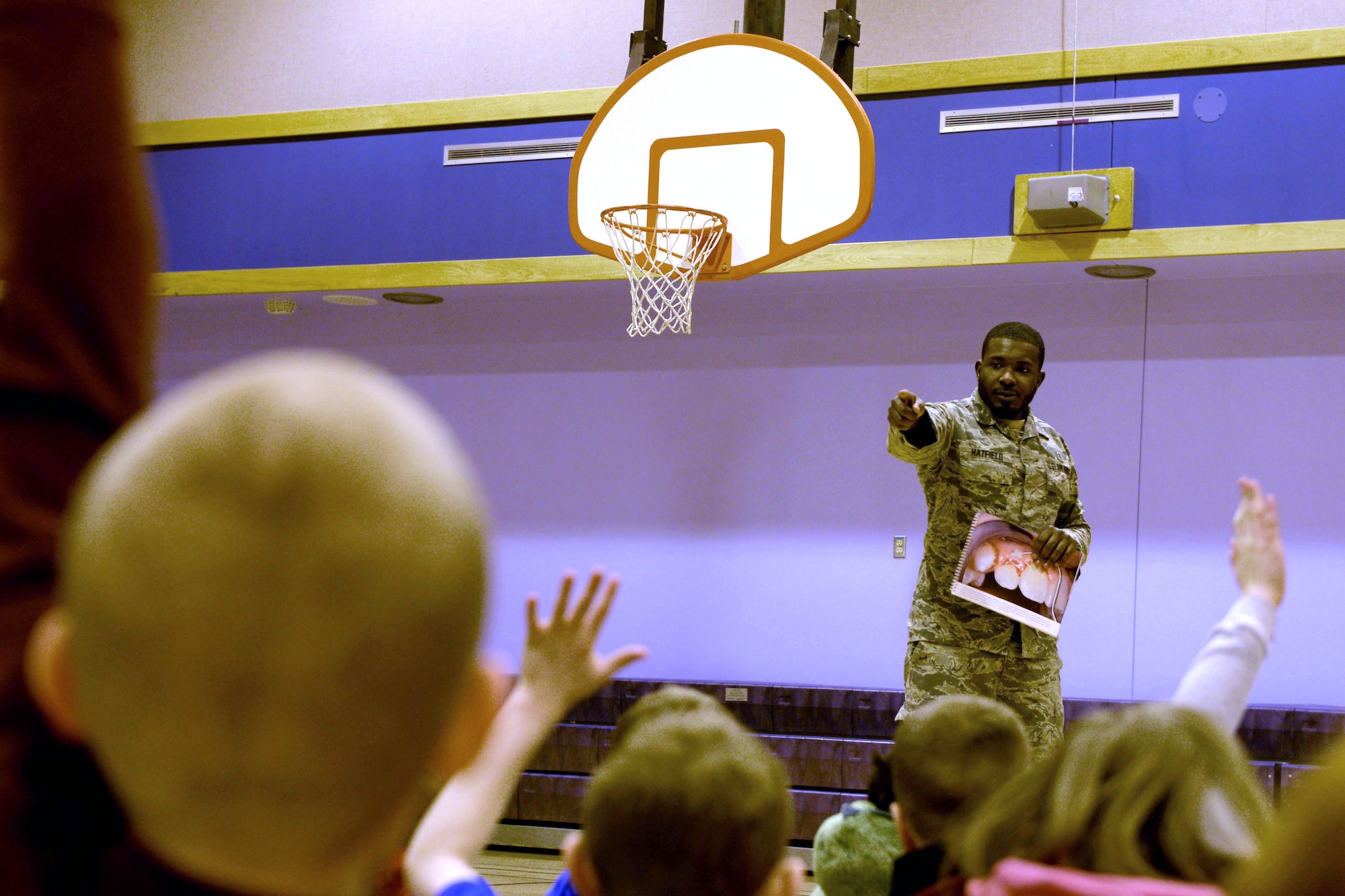 U.S. Air Force Staff Sgt. Kaleb Hatfield, a 354th Medical Group Dental Flight dental assistant, asks Crawford Elementary School students questions about dental hygiene at Eielson Air Force Base, Alaska, Feb. 13, 2020.