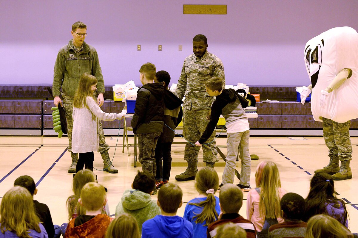 U.S. Air Force Capt. Anthony Ewell-Kollmann, a 354th Medical Group Dental Flight general dentist, and Staff Sgt. Kaleb Hatfield, a 354th MDG Dental Flight dental assistant, lead a dental flossing activity with a jump rope at Crawford Elementary School at Eielson Air Force Base, Alaska, Feb. 13, 2020.