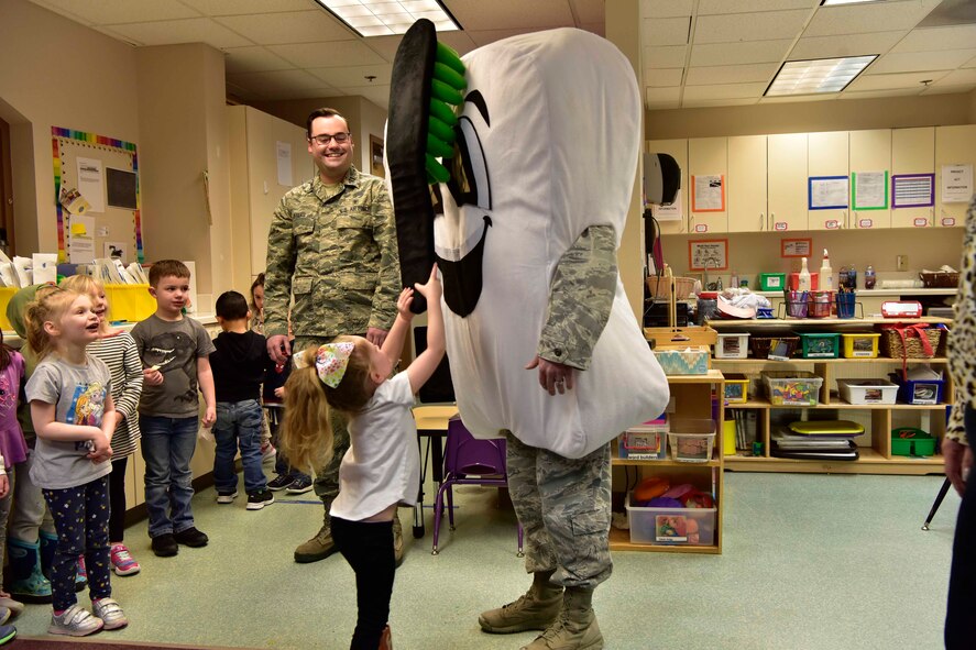 A child practices her tooth brushing technique on a tooth mascot at the child development center on Eielson Air Force Base, Alaska, Feb. 11, 2020.