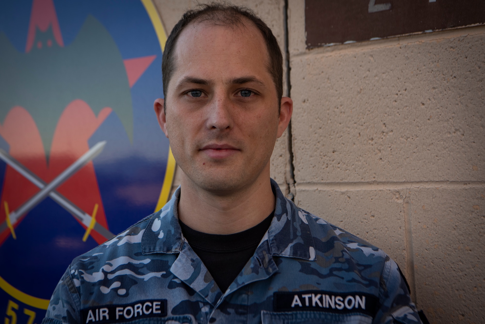 Royal Australian Air Force member,  poses for a photo.