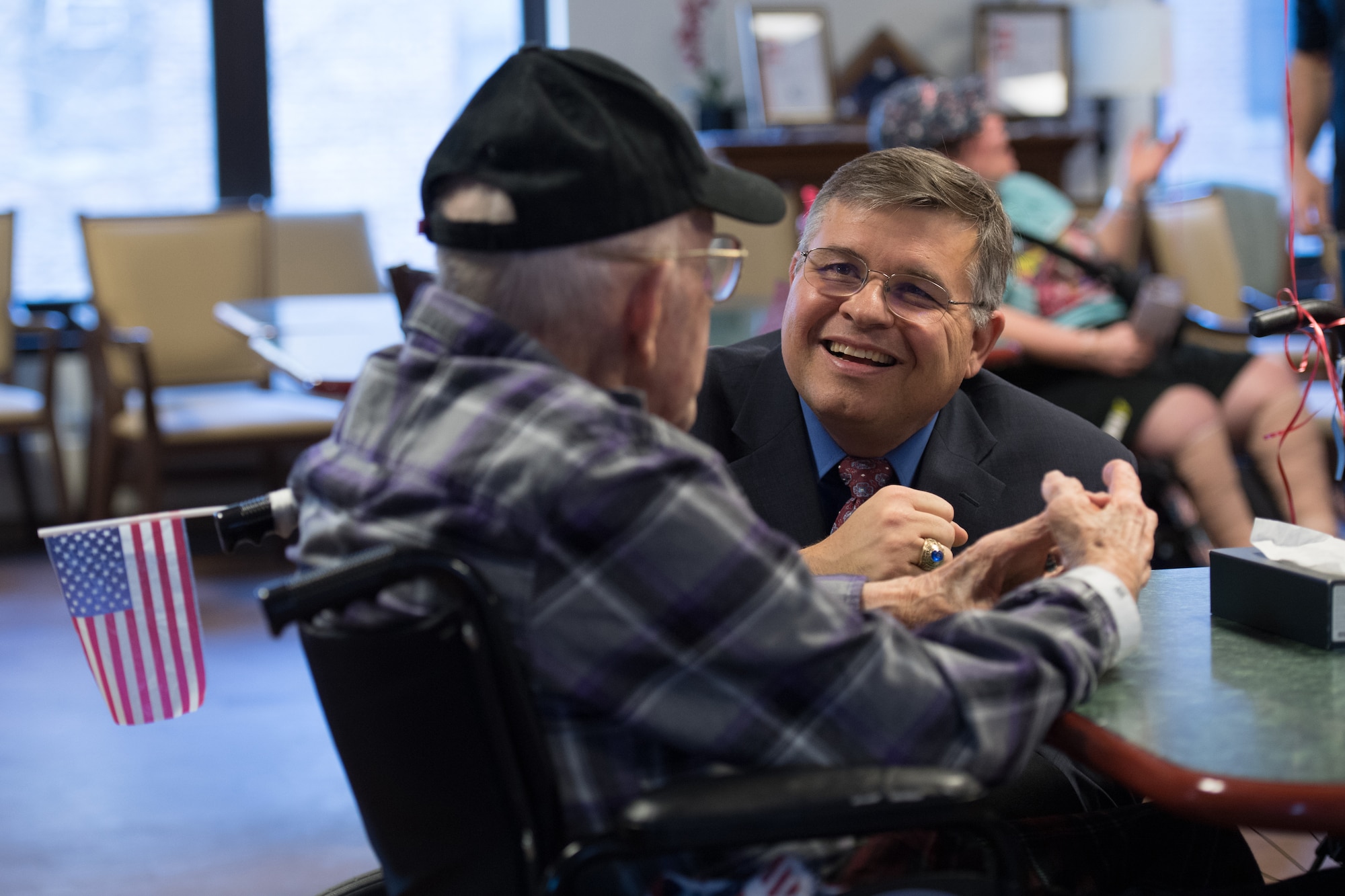 Tom Fredericks, 66th Air Base Group deputy director, speaks to retired Sgt. 1st Class Charles Pellerin, a 92-year-old WWII and Korean War veteran at the Edith Nourse Rogers Memorial Veterans Hospital in Bedford, Mass., Feb. 14. The event was part of National Salute to Patients Week, a time established to encourage American citizens to visit hospitalized veterans in Department of Veterans Affairs facilities. (U.S.  Air Force photo by Jerry Saslav)