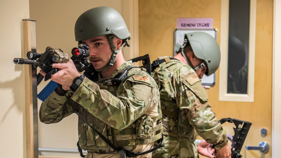 Senior Airman Richard Nicholas, 412th Security Forces Squadron, moves down a hallway to secure it during an active shooter exercise at Edwards Air Force Base, California, Feb. 11. (Air Force photo by Richard Gonzales)